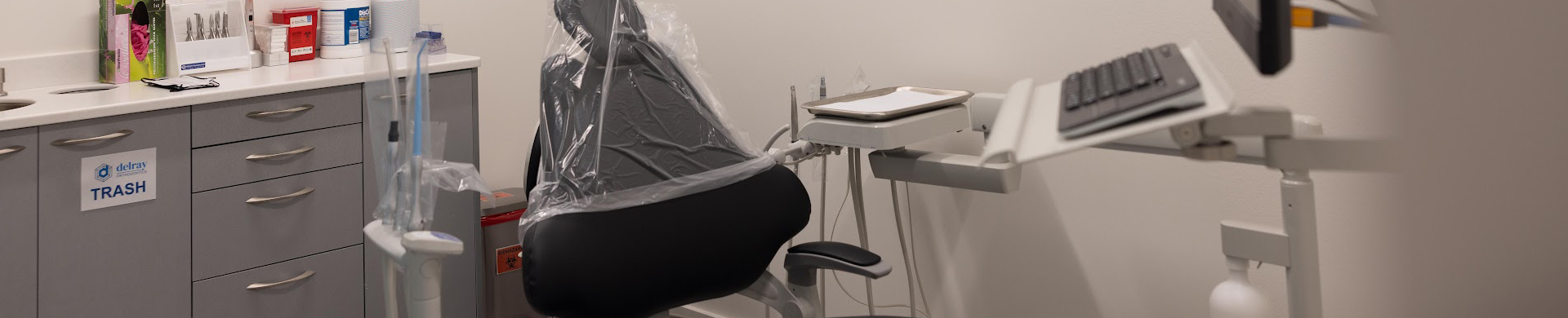 Modern orthodontic treatment chair with dental equipment in a professional clinical office setting.