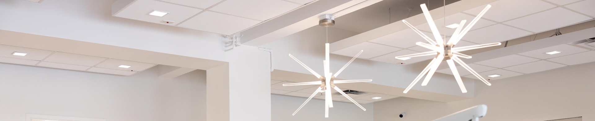 Modern dental office ceiling with recessed lighting and contemporary star-shaped fixtures.